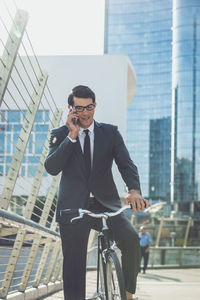 Young man using mobile phone in city