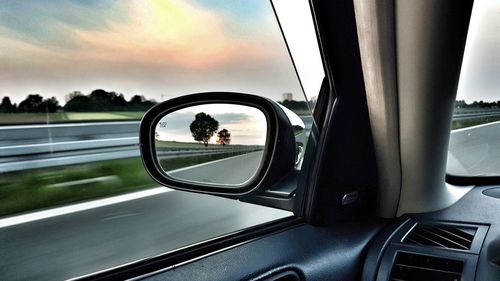 Reflection of car on side-view mirror