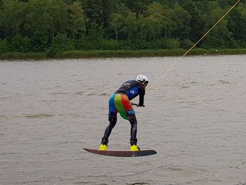 Full length of man jumping in water