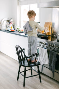 Boy preparing food in kitchen