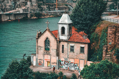 View of building and trees by canal