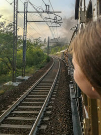 Rear view of train on railroad track against sky