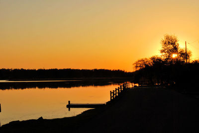 Scenic view of calm lake at sunset