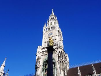 Low angle view of new town hall against clear blue sky in city