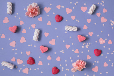 Directly above shot of cookies on pink background