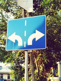 Close-up of road sign against sky