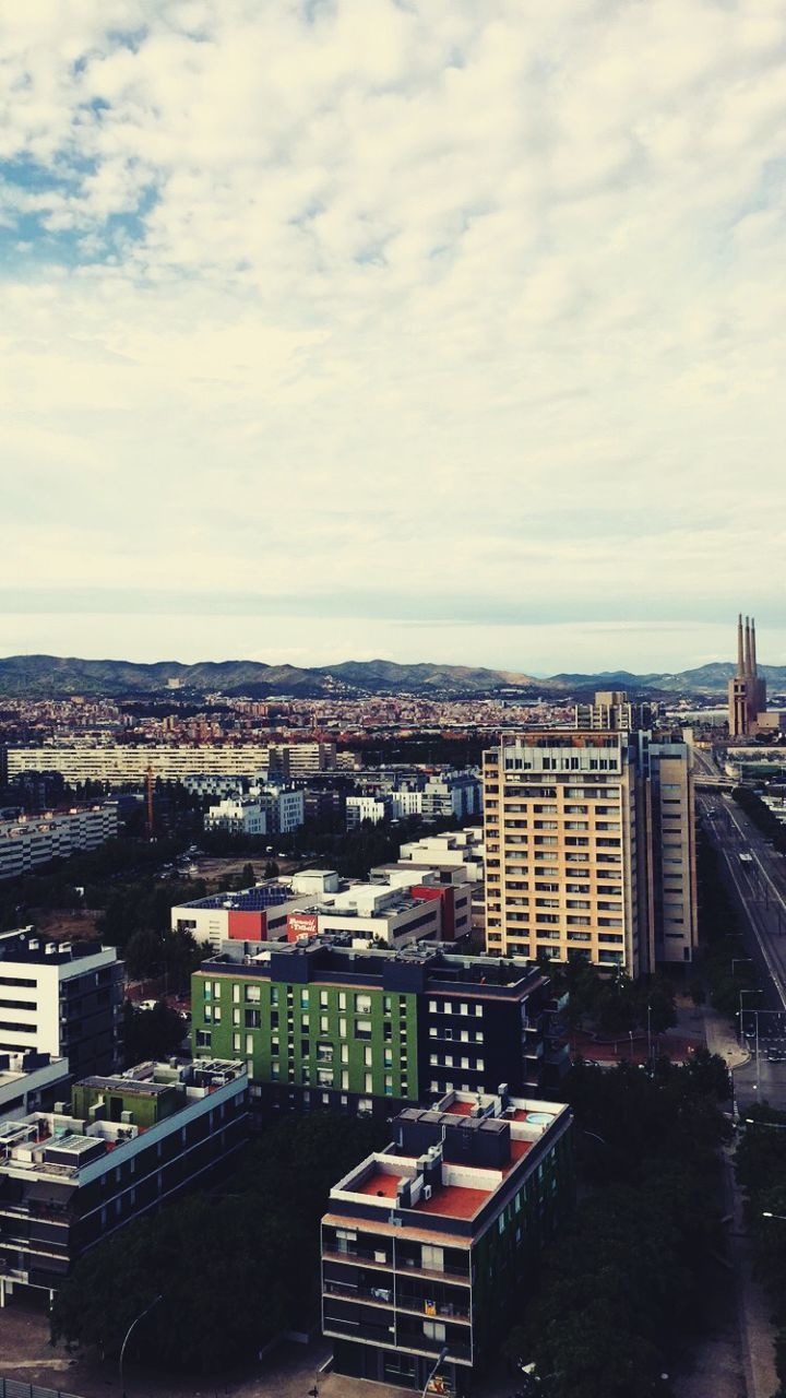 building exterior, architecture, built structure, city, sky, cityscape, high angle view, cloud - sky, crowded, residential district, residential building, residential structure, cloudy, cloud, city life, roof, day, outdoors, elevated view, community