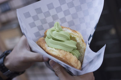 Close-up of hand holding ice cream