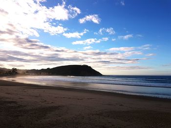 Scenic view of beach against blue sky