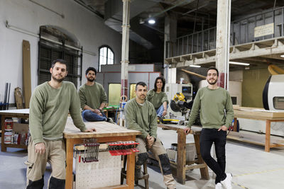 Male and female furniture designers at workshop
