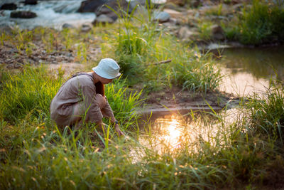 Side view of man working in water