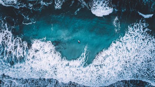High angle view of people swimming in sea