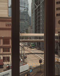 Reflection of buildings in city seen through glass window