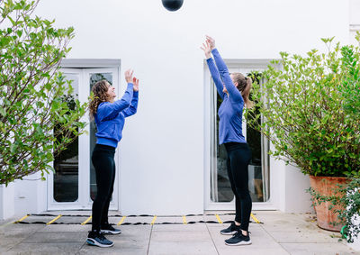 Beautiful woman playing with ball outdoors