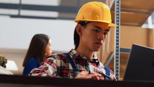 Rear view of man working in factory