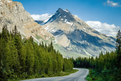 Scenic view of road with snowcapped mountains against sky - icefield parkway, canada