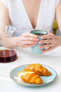 Midsection of woman holding coffee