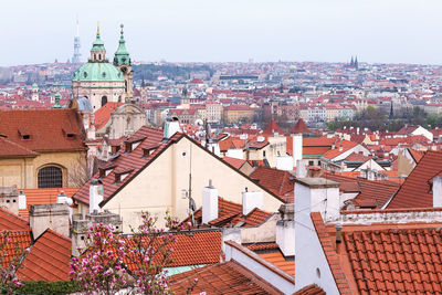 Spring aerial view on houses and old roofs of prague old city st. nicholas church. czech republic