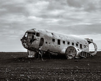 The wreckage of a crash landed transport plane on the black sand beaches of iceland.