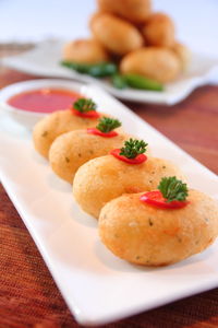 Close-up of served food in plate on table