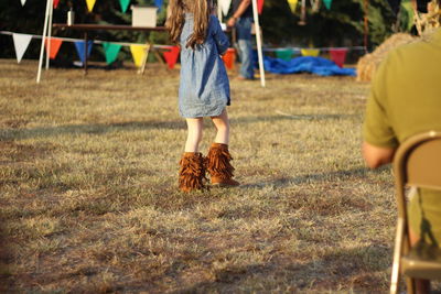 Low section of child playing on grassy field