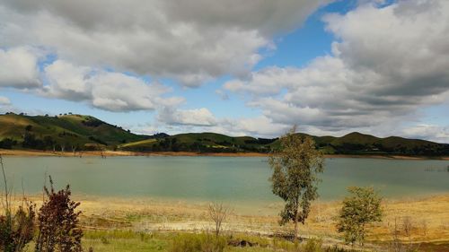 Scenic view of lake against cloudy sky