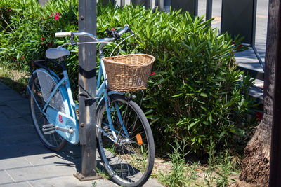 Bicycle in basket on footpath