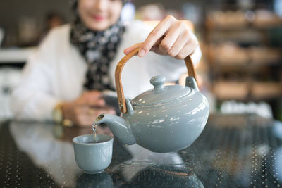 Midsection of woman holding ice cream cone