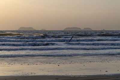 Scenic view of sea against clear sky during sunset