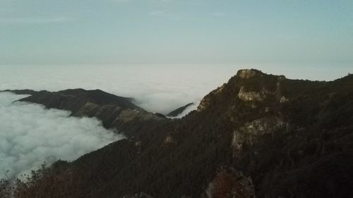 Scenic view of sea and mountains against clear sky