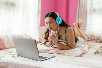 Young woman using laptop at home