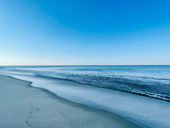 Scenic view of sea against clear blue sky