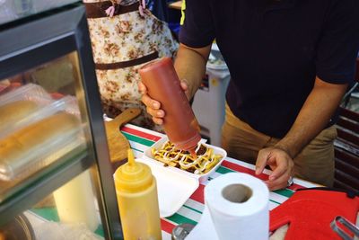 Midsection of man preparing food