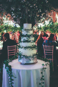 Close of cake on table with people in background