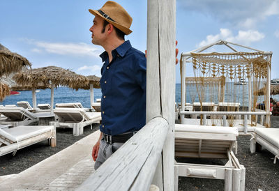 Man standing by sea against sky