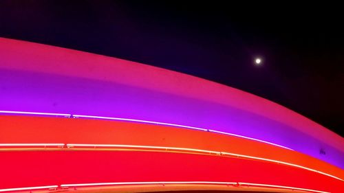 Low angle view of illuminated rainbow against sky at night