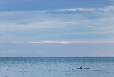 Scenic view of sea and oar against sky