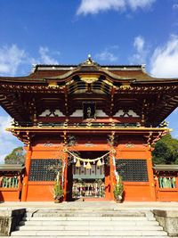 Facade of temple against cloudy sky