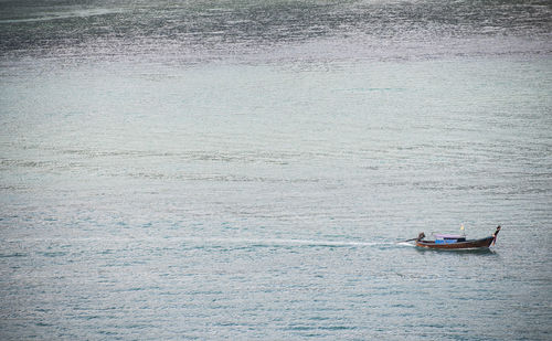 Man in boat sailing on water