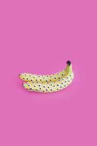 Close-up of banana on pink background