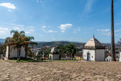 Panoramic view of buildings in town against sky