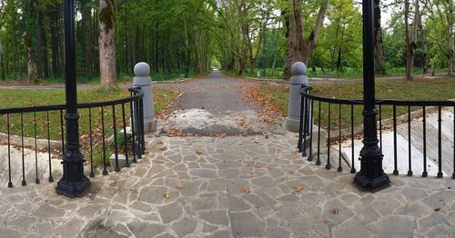 Railing by trees against sky