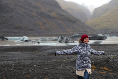 Full length of woman standing on mountain