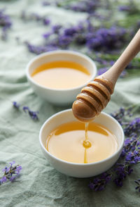 Bowls of honey, honeycomb and lavender flowers