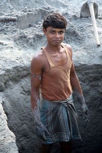 Portrait of young man standing on rock