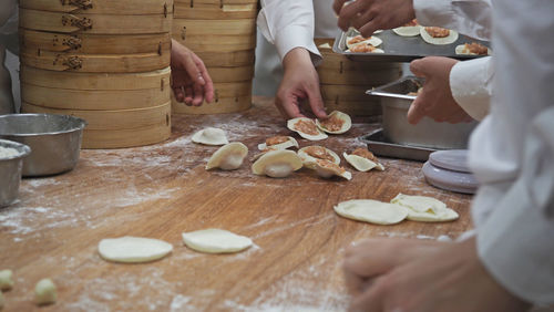 Midsection of woman preparing food at table
