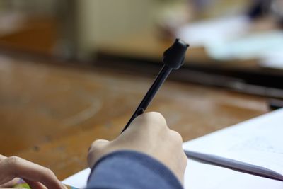 Close-up of person writing on paper