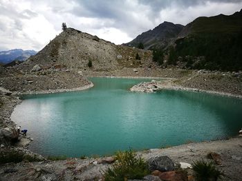 Scenic view of lake and mountains against sky