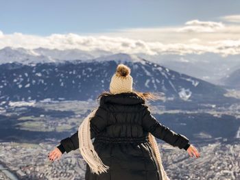 Rear view of woman on mountain against sky