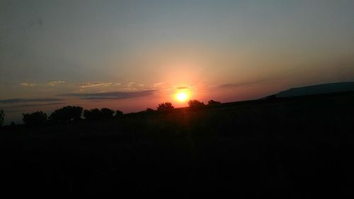 Scenic view of silhouette landscape against sky during sunset